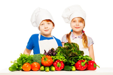 Happy young cooks with fresh vegetables