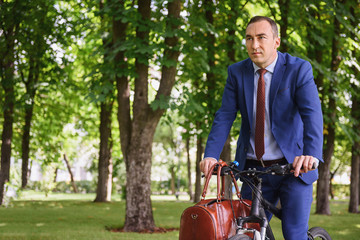 Pensive businessman riding a bicycle