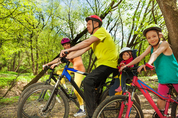 Sporty family bike trip in the sunny spring forest