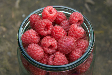 glass jar filled with raspberries