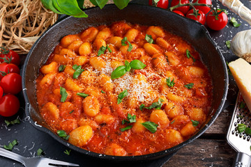 Homemade Italian Gnocchi with marinara sauce, cheese in iron pan