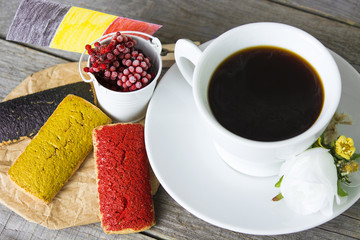 cookies with red black and yellow glaze as the Belgian flag colors. cup of coffee and a homemade flag of Belgium, decorative patriotic breakfast and lunch National Day. Selective focus photo image