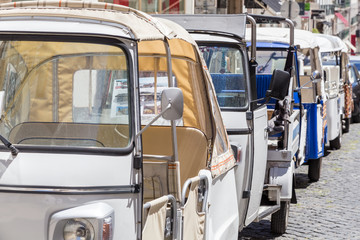 small transport tuk-tuk for tourists on european street