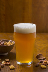 Glass of Beer with Foam and Snacks