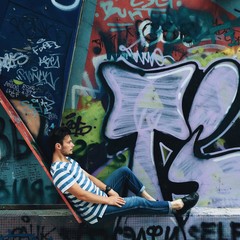 man near the wall with graffiti