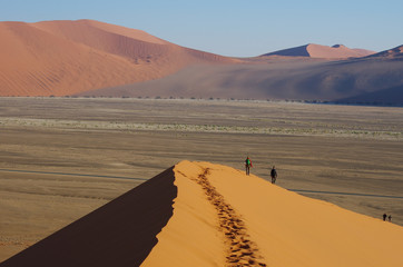 Fototapeta na wymiar Hikers on the dunes, Namibia