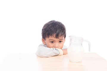 Cute little boy bored with milk