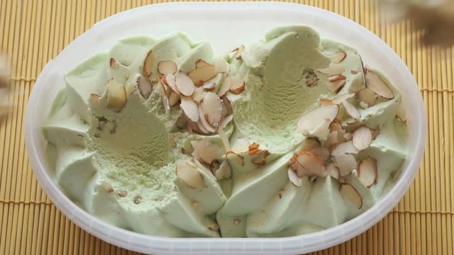 People take the pistachio ice cream of a container