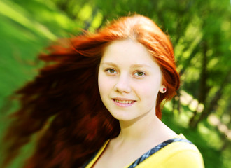 smiling redhaired girl, outdoors 