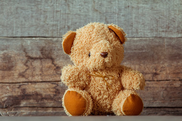Cute teddy bears sitting on old wood background