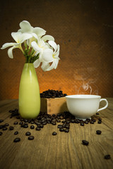 coffee cup and coffee bean on wooden