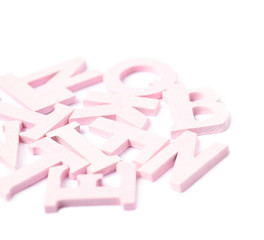 Pile of colorful wooden letters isolated