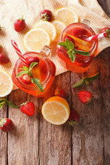 Summer strawberry lemonade with peppermint close-up. Vertical top view

