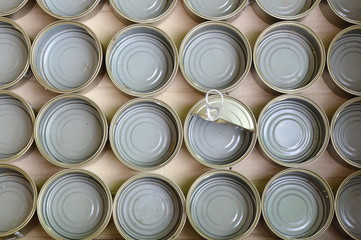 empty tin food can in brown paper box