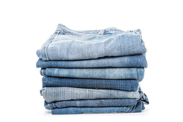 stack of jeans on white background
