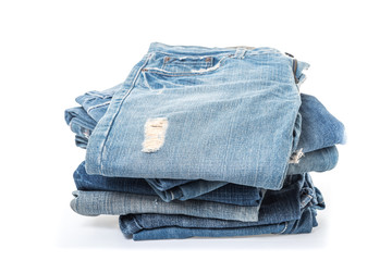 stack of jeans on white background