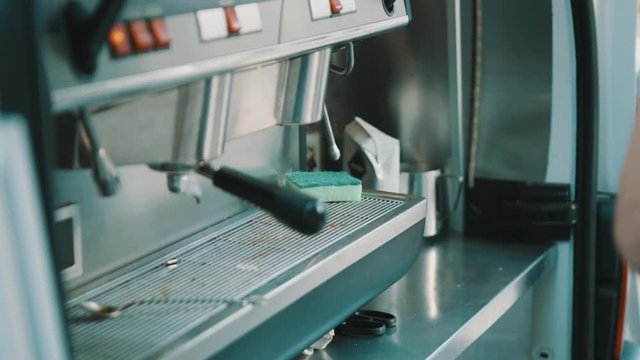 ARMAVIR, RUSSIA - JULE 16, 2016: Man the seller is making coffee in the coffee machine in the cafeteria