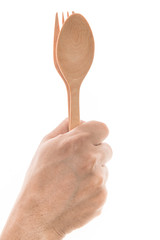 Men hand holding wooden spoon and fork