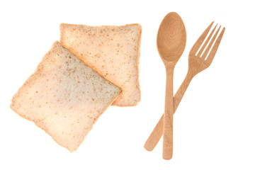 Wooden spoon and frok and whole grain bread on white background