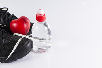 Fitness background with bottle of water , shoes and heart