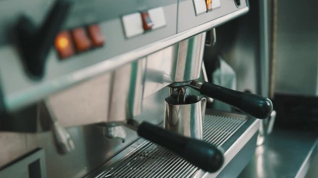 ARMAVIR, RUSSIA - JULE 16, 2016: Man the seller is making coffee in the coffee machine in the cafeteria