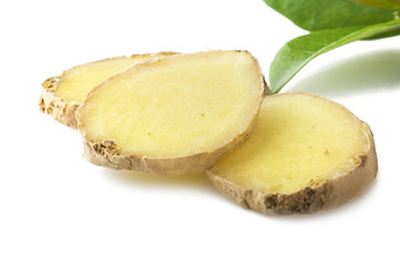 Fresh sliced ginger root and leaves on the white