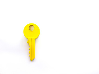 Yellow toy key on white background