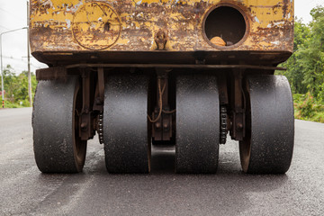 Road construction works with roller compactor machine and asphalt finisher
