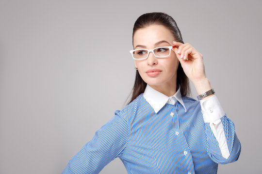 Portrait of young businesswoman smiling in eyeglasses