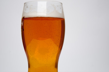 Glass of light beer isolated on a white background
