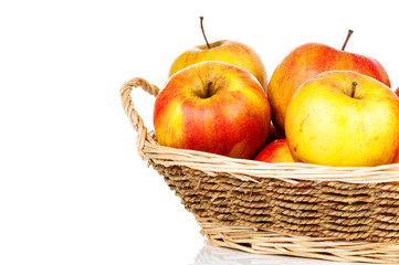 Fresh apples in the wicker on white background