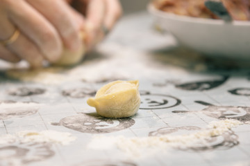 Cooking homemade ravioli on the table, floured
