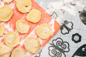 Cooking homemade ravioli on the table, floured