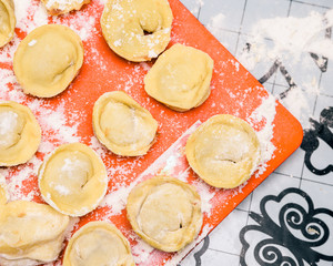 Cooking homemade ravioli on the table, floured