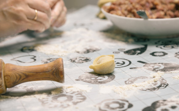 Cooking homemade ravioli on the table, floured