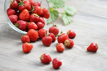 Healthy strawberries in bowl on wooden table. Selective focus, high resolution product. Harvest Concept