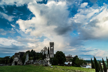 storm over an ancient and ruined castle in the italian countrysi