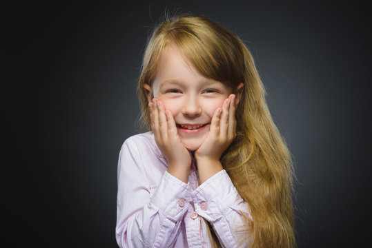 Closeup Portrait happy girl going surprise isolated on gray background