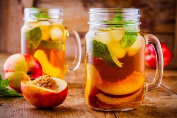 Peach ice tea in mason jar with mint