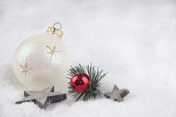 Christmas ball and stars in the snow