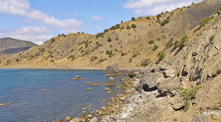 Crimean mountains on the rocky shore of the sea Bay.