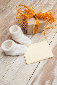 white knitted booties. Small children's socks, greeeting card