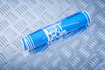 Blue engineering drawings on channeled metal plate construction 