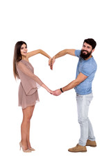 Love's language. Beautiful young couple smiling and showing symbol of heart by their hands isolated on white background.