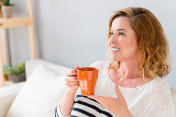 Joyful mature lady relaxing at home