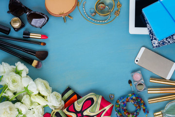 styled feminine desktop - woman fashion flat lay items and flowers on blue wooden background, copy space, top view