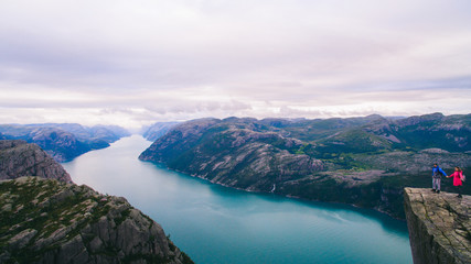 couple in love Preikestolen massive cliff (Norway, Lysefjorden s