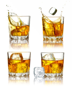 Set of scotch whiskey glasses with splash and ice isolated