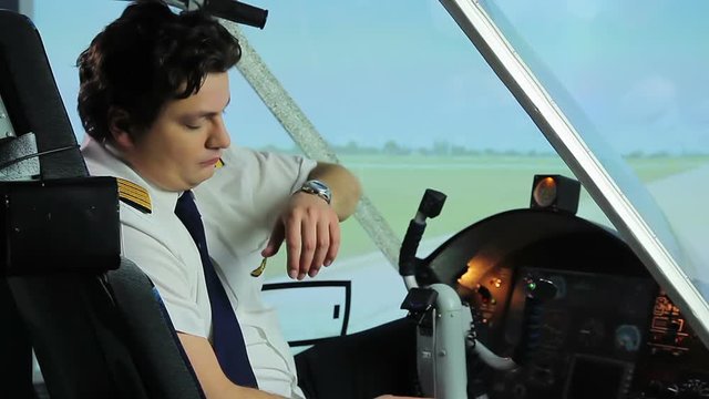 Overworked airplane pilot sitting in cockpit and dreaming of vacation, hard work