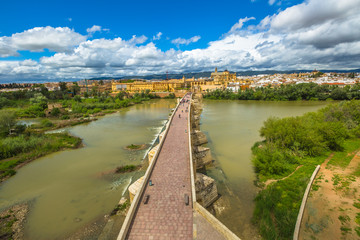 Fototapeta na wymiar Aerial view to the Roman Bridge on the Guadalquivir river, seen from the Calahorra Tower in Cordoba, Andalusia, Spain.